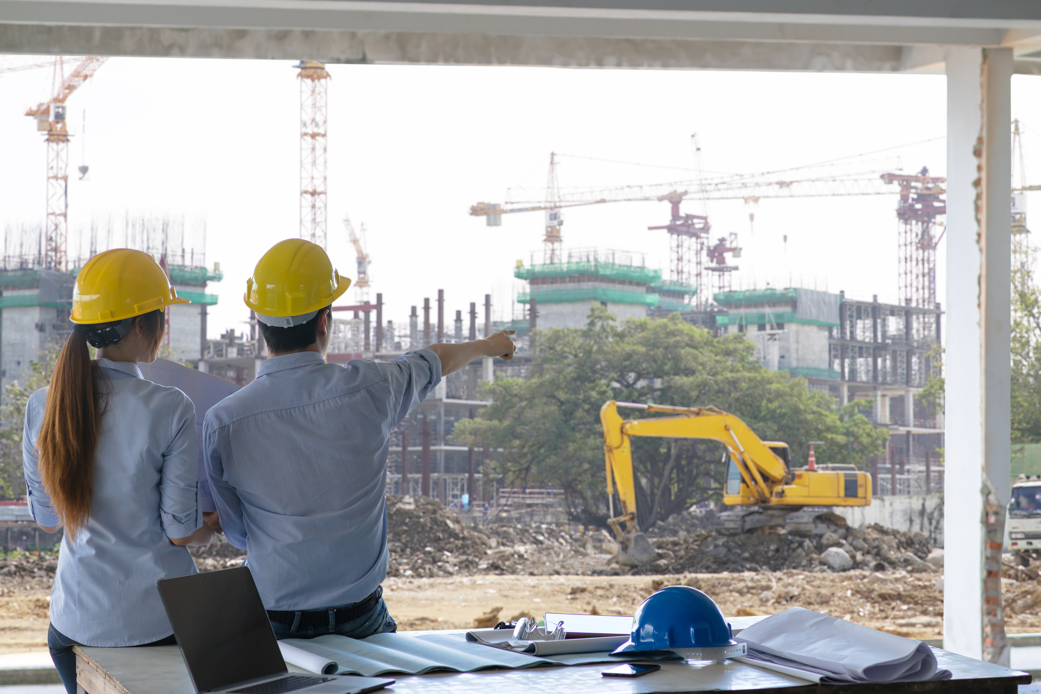 engineer-group-and-worker-meeting-discussion-with-construction-blueprint-on-site-work-and-point-finger-to-the-work-site.jpg
