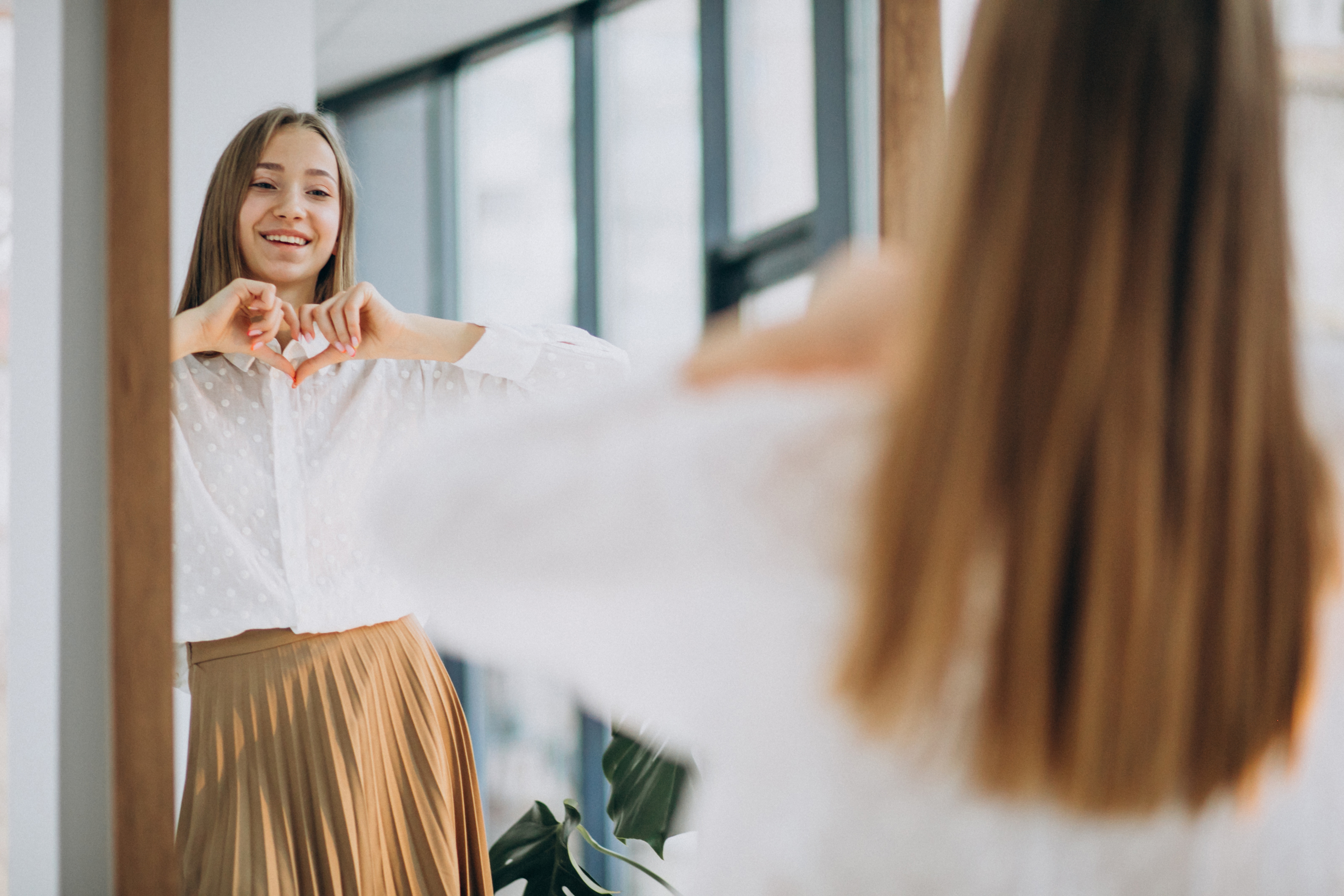 pretty-young-woman-in-casual-outfit-looking-into-mirror.jpg