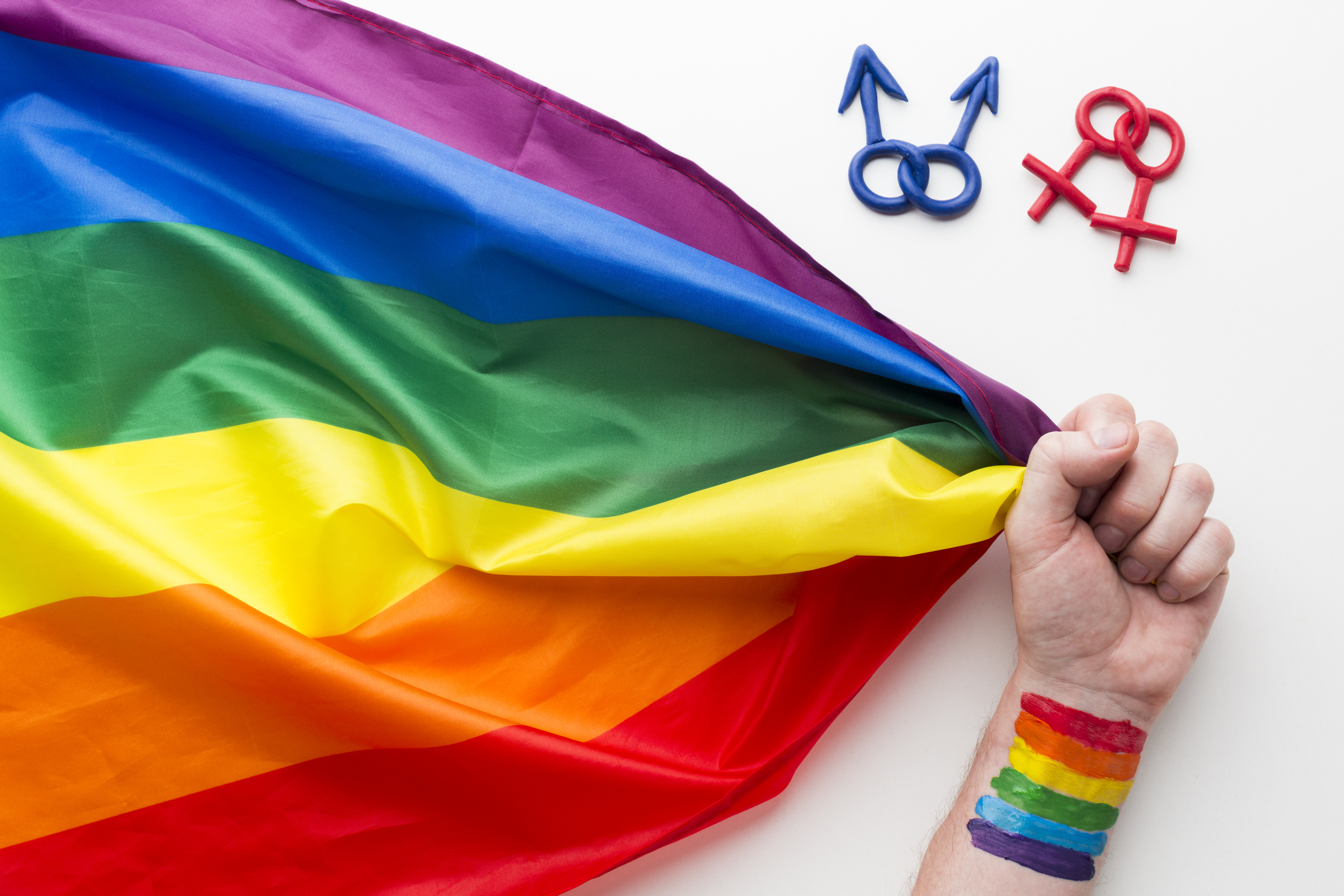 rainbow-pride-flag-with-hand-and-symbols.jpg