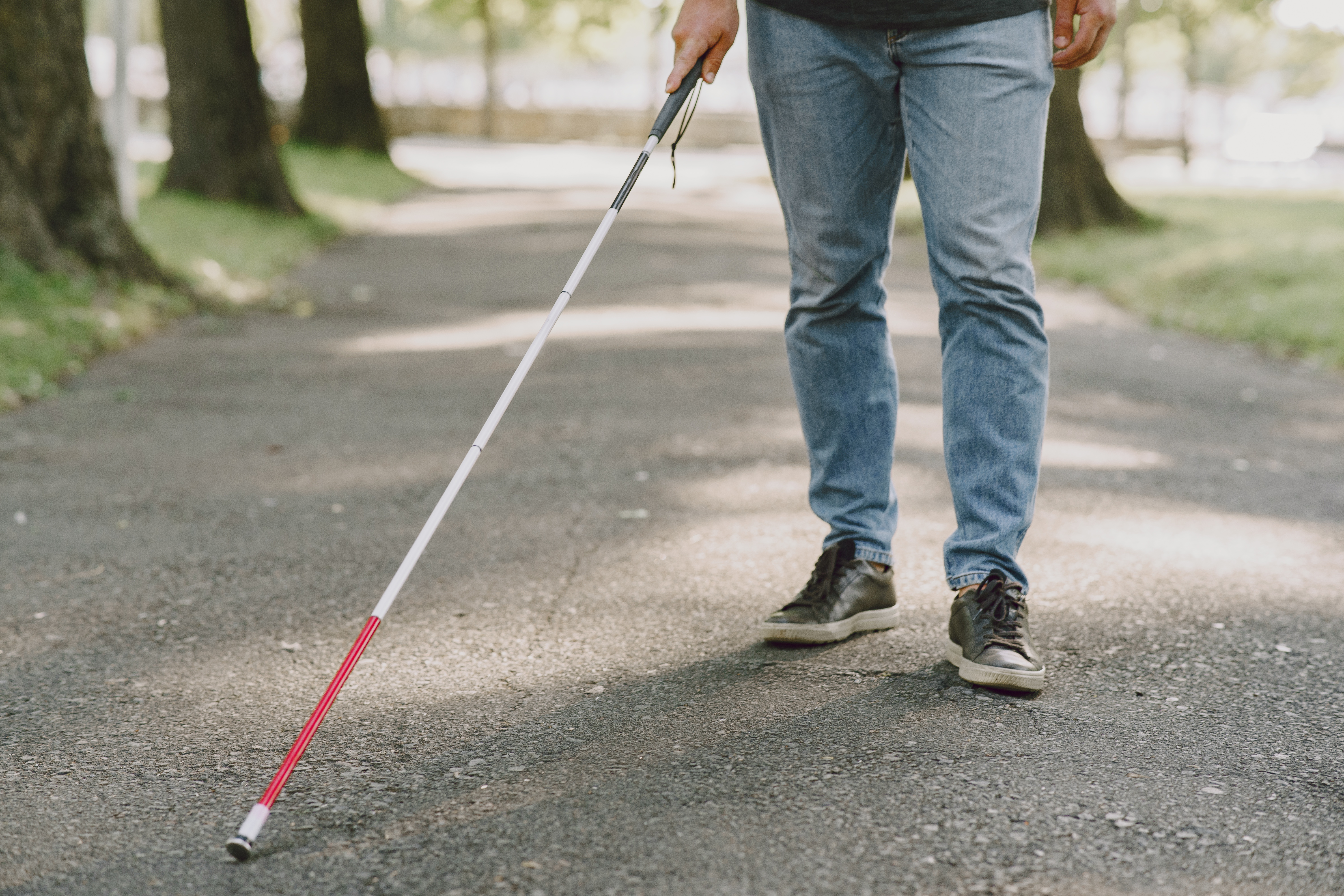 blind-man-people-with-disability-handicapped-person-and-everyday-life-visually-impaired-man-with-walking-stick-descending-steps-in-city-park.jpg